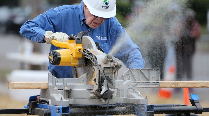 Former President Jimmy Carter, uses a miter saw on a 2x4 while working on a Habitat for Humanity construction site Monday morning in Memphis. Ben Gray,bgray@ajc.com