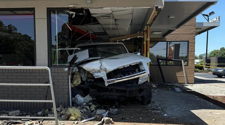 Lawrenceville police plan to file reckless driving charges, among others, against the driver of a white SUV that crashed into a Burger King on Grayson Highway.