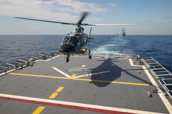A Philippine Navy AW109 Helicopter lands on board Philippine Navy Ship Jose Rizal as US Navy USS Shoup (DDG86), background right, and Japanese Maritime Self-Defence Force (JMSDF) frigate JS Noshiro, center, maneuver during the Philippines United States Japan Multilateral Maritime Cooperative Activity off a disputed South China Sea shoal on Friday, March 28, 2025. (AP Photo/Aaron Favila)