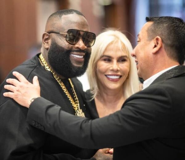 Rick Ross and Mario Montoya embrace during the grand opening of Smiles by Mario Montoya on March 20, 2025 in Sandy Springs, Ga.