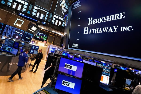The logo for Berkshire Hathaway Inc. appears above a trading post on the floor of the New York Stock Exchange, Monday, May 5, 2025. (AP Photo/Richard Drew)