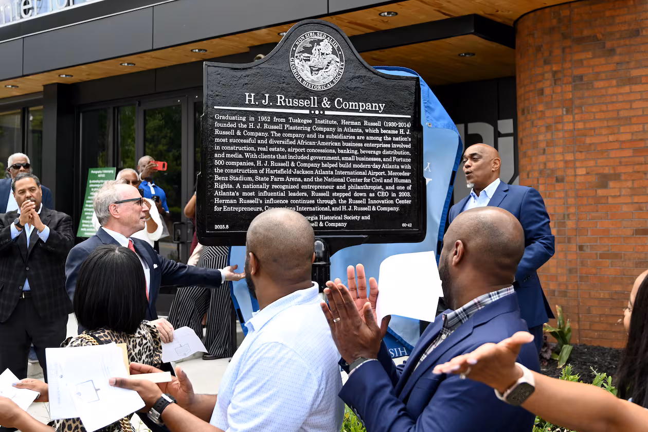 W. Todd Groce (left), president and CEO of the Georgia Historical Society, and Michael B. Russell Sr., CEO of H.J. Russell & Co, unveil a marker commemorating the company’s original headquarters April 29, 2026. (Hyosub Shin/AJC)