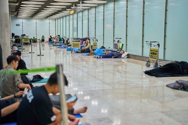 People sleep on the floor of Terminal 4 at Adolfo Suarez-Madrid Barajas Airport in Madrid, Spain, Thursday, May 15, 2025. (AP Photo/Manu Fernandez)