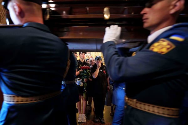 Women cry while honor guards carry the coffin of Ukrainian F-16 pilot Maksym Ustymenko, during a farewell ceremony in Kyiv, Ukraine, on Thursday, July 3, 2025. (AP Photo/Evgeniy Maloletka)