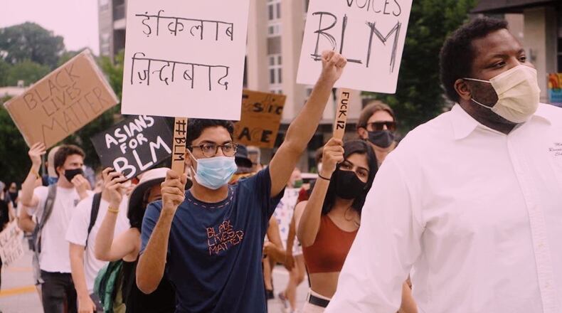 Samir Duggasani, a rising senior at Alpharetta High School, marched in recent protests in downtown Atlanta and Decatur. He is pictured with sign written in Urdu and Hindu that includes the phrase, "Long live the revolution." Photo courtesy of Samir Duggasani.