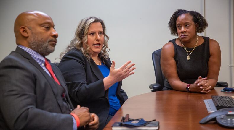 Investigator Crispin Henry (from left), prosecuting attorney Agatha Romanowski and DeKalb County District Attorney Sherry Boston talk about closing a 24-year-old sexual assault case.