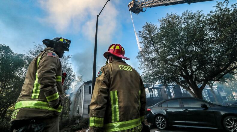 Cobb County fire crews worked through the early morning hours on Friday, April 21, 2023, following a fire in Austell in this AJC file photo. The county will vote on entering a consent decree with the U.S. Department of Justice over the fire department's hiring practices. (John Spink / John.Spink@ajc.com)