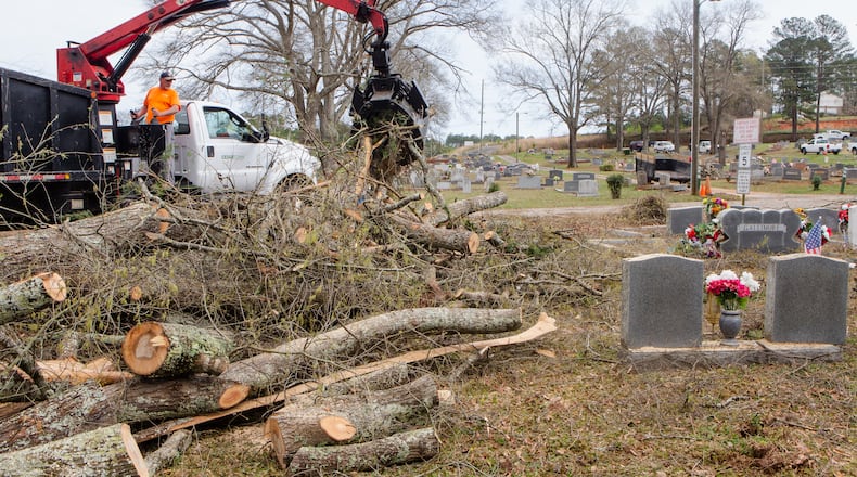 Reed Runyon moves fallen lumber left from a storm in Cedartown.