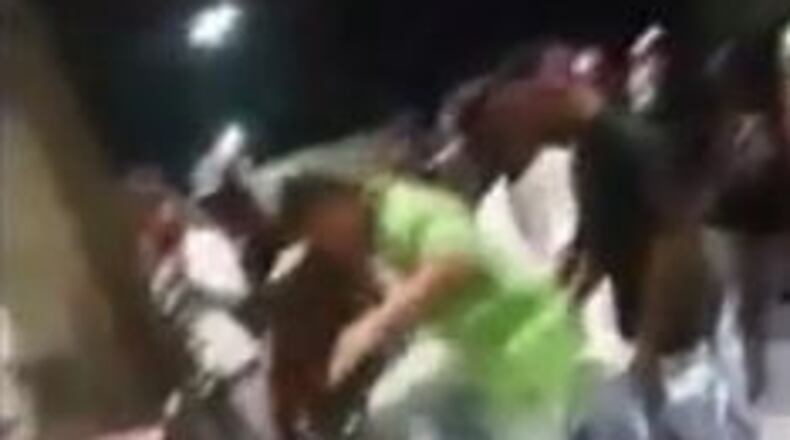 The human in the green shirt is 15, doesn't go to school, and was out of jail on gun charges when he kicked another human unconscious. (Image taken from video)