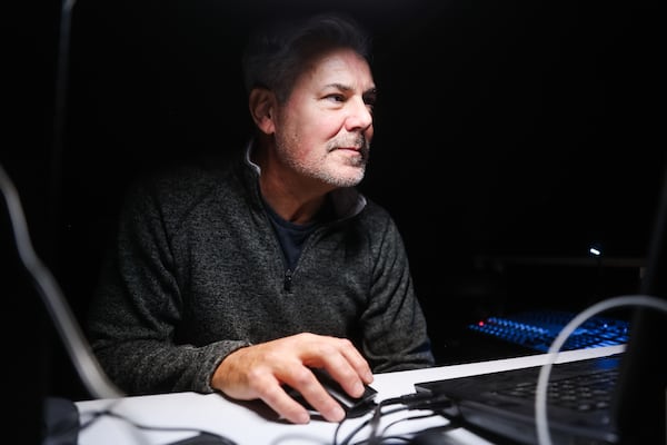 Scott Ross adjust lights as he staffs the tech booth during a cue-to-cue rehearsal of “Doubt: A Parable” at Merely Players Theatre in Doraville, on Sunday, Jan. 4, 2026. Ross also directs and produces the play. (Abbey Cutrer/AJC)