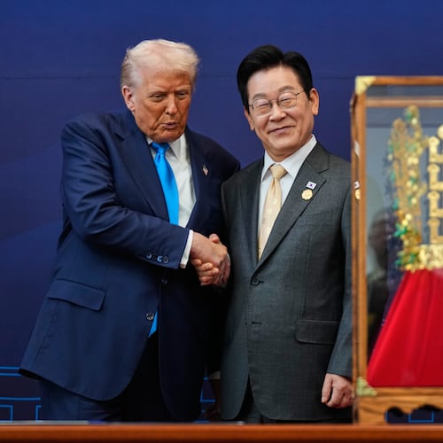 President Donald Trump shakes hands with South Korean President Lee Jae Myung as he receives a gift of a gold crown and an award of the Grand Order of Mugunghwa, not seen, during a high honor ceremony at the Gyeongju National Museum in Gyeongju, South Korea, Wednesday, Oct. 29, 2025. (AP Photo/Mark Schiefelbein)