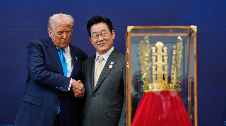 President Donald Trump shakes hands with South Korean President Lee Jae Myung as he receives a gift of a gold crown and an award of the Grand Order of Mugunghwa, not seen, during a high honor ceremony at the Gyeongju National Museum in Gyeongju, South Korea, Wednesday, Oct. 29, 2025. (AP Photo/Mark Schiefelbein)