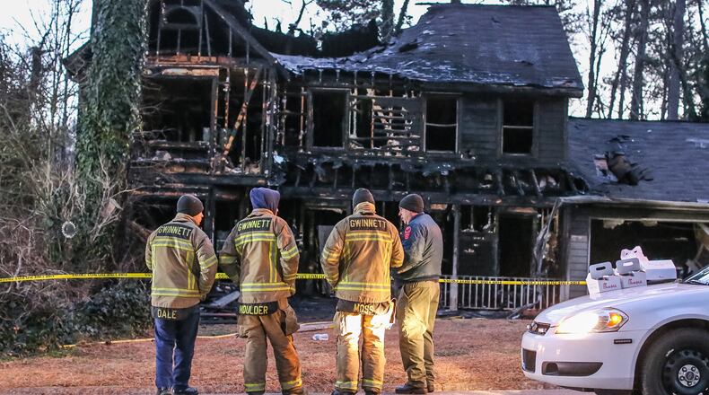 A fire that led to the deaths of a mother and her two daughters had demolished much of the home by Wednesday, Feb. 10, 2016. JOHN SPINK / JSPINK@AJC.COM