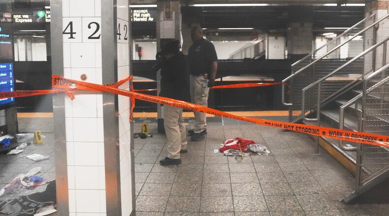 Police investigate the scene after a reported stabbing and shooting at the Grand Central subway station in New York on Saturday, April 11, 2026. (AP Photo/Ryan Murphy)