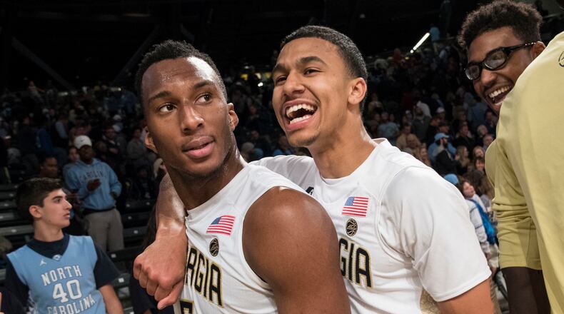 Georgia Tech’s Justin Moore, right, celebrates with teammate Josh Okogie (5) after the Yellow Jackets’ upset victory against North Carolina on Saturday. Tech won 75-63. (AP Photo/John Amis)