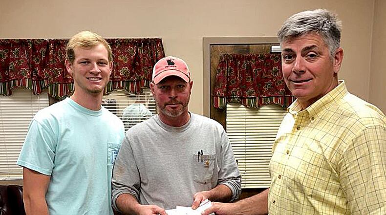 Brantley Wommack (left) and his father Mark received a $5,500 reward Tuesday from Walton County Sheriff Joe Chapman for leading deputies to an accused killer.
