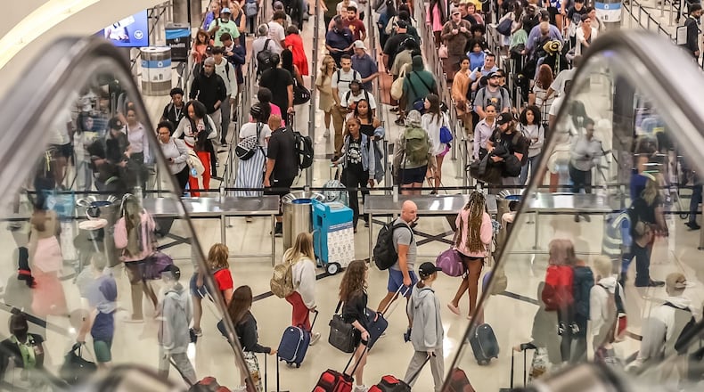 Crowds flood into Hartsfield-Jackson International Airport during peak travel for the Fourth of July. Photo by John Spink / jspink@ajc.com