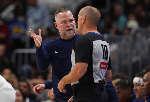 Denver Nuggets head coach Michael Malone, left, argues for a call with referee John Goble (10) in the first half of an NBA basketball game against the Utah Jazz, Friday, March 28, 2025, in Denver. (AP Photo/David Zalubowski)