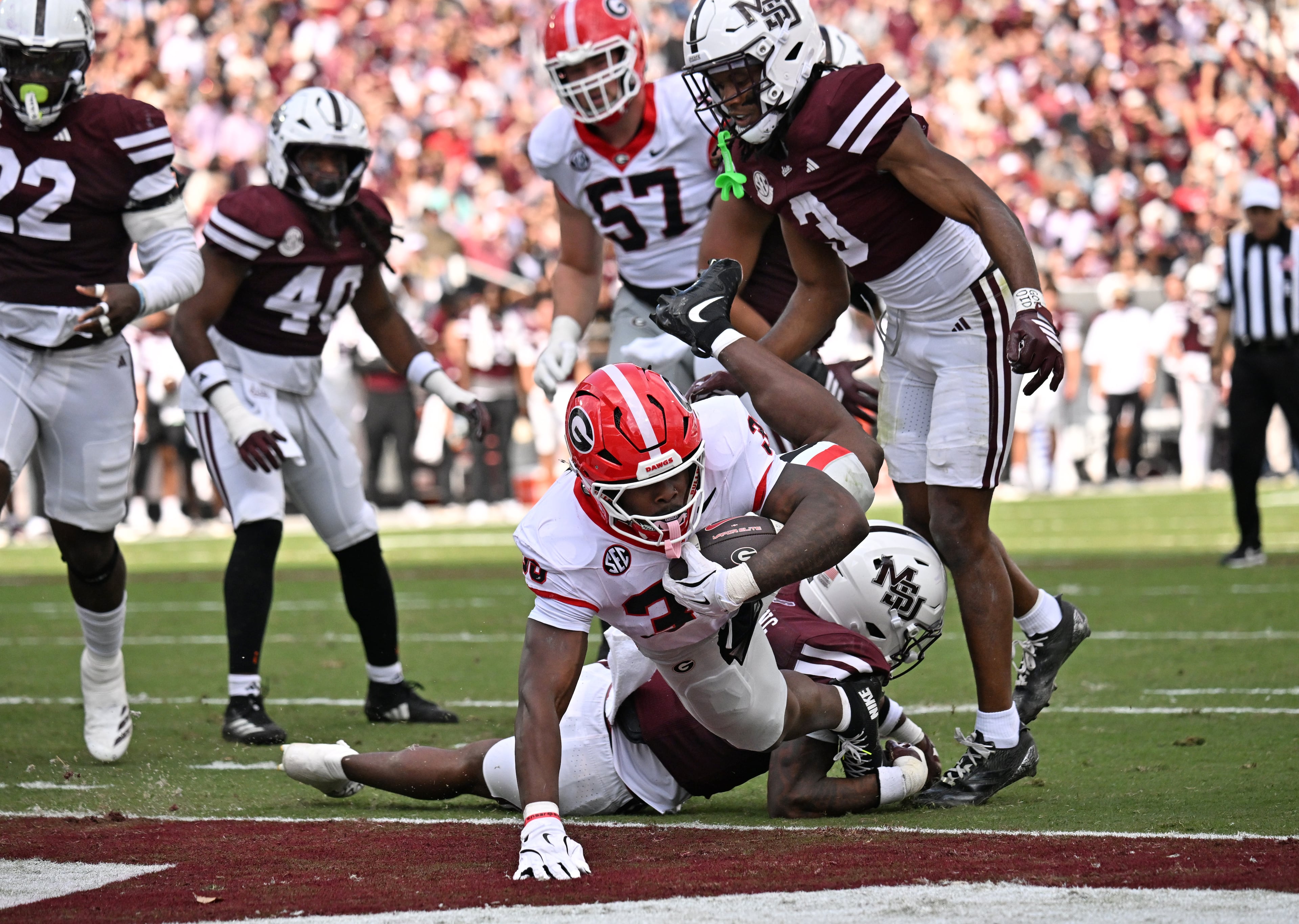 Georgia running back Chauncey Bowens (33) falls into the end zone past Mississippi State safety Jahron Manning (13) for a touchdown during the first half in an NCAA football game at Davis Wade Stadium, Saturday, November 8, 2025, in Starkville, Mississippi. (Hyosub Shin / AJC)