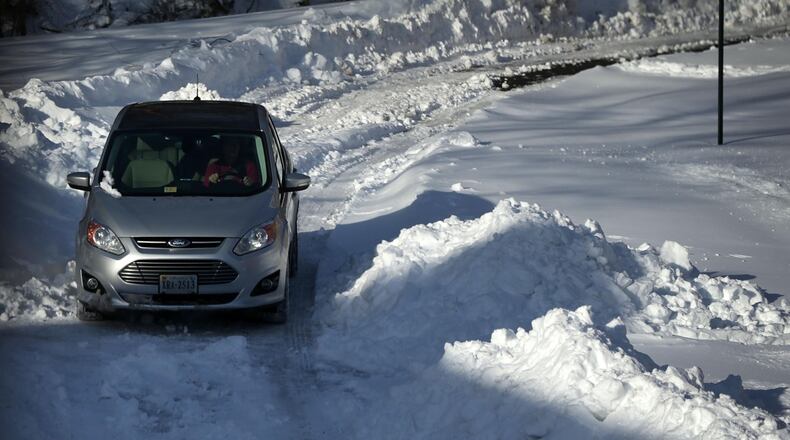 FILE PHOTO: A driver navigates on a snow-covered driveway.