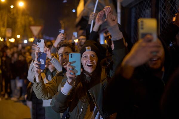 Locals chant and greet a group of students who walked across the country as they arrive at an anti-corruption protest in the southwestern town of Novi Pazar, Serbia, Friday, April 11, 2025. (AP Photo/Marko Drobnjakovic)