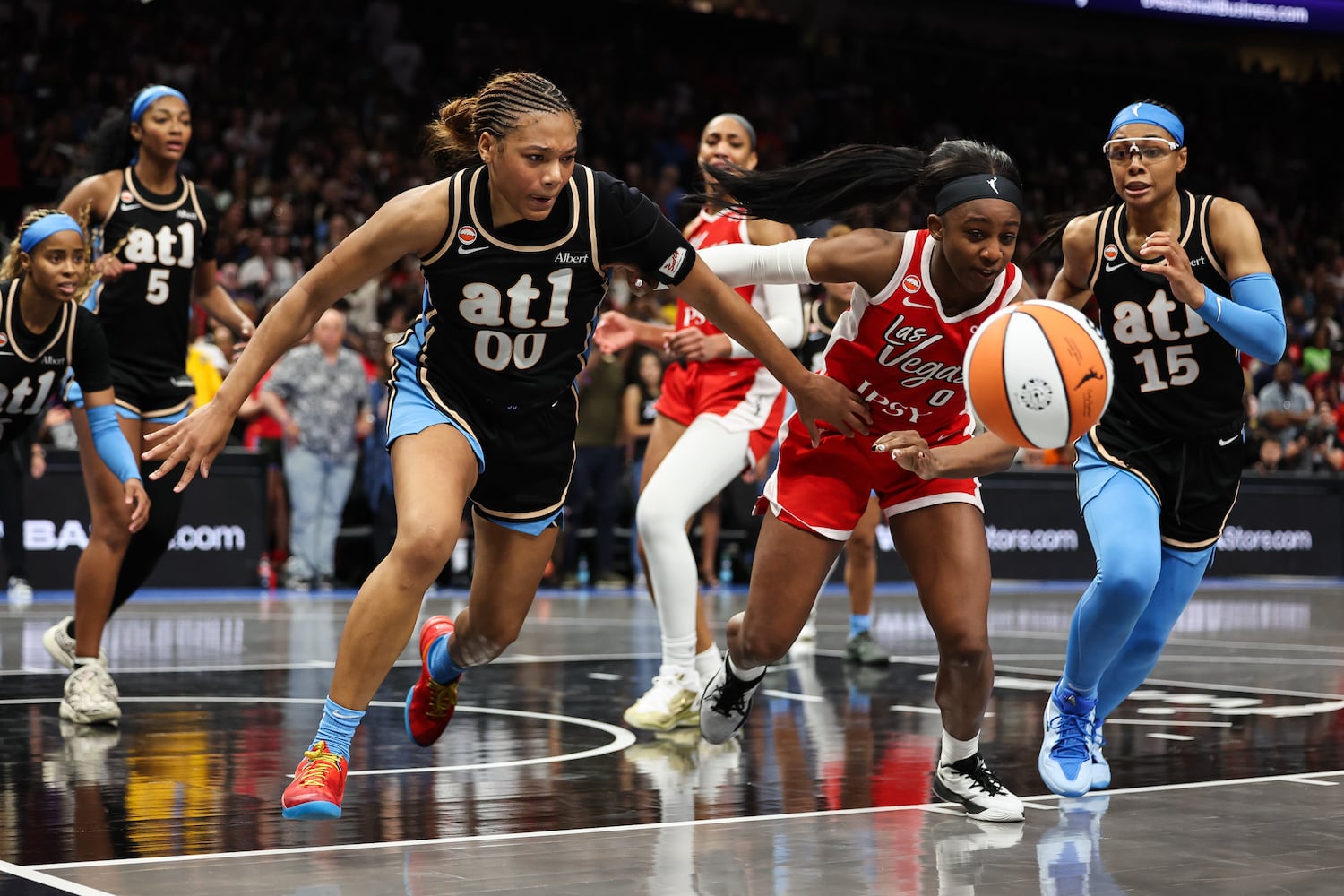 Atlanta Dream forward Naz Hillmon (00) fight for a loose ball against Las Vegas Aces guard Jackie Young, right, during the second half of a WNBA game at State Farm Arena on Sunday, May 17, 2026, in Atlanta. (Colin Hubbard for the AJC) 