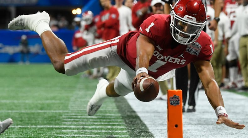 Oklahoma quarterback Jalen Hurts (1) scores a touchdown against LSU during the Peach Bowl on Dec. 28, 2019. (AP Photo/John Amis, File)