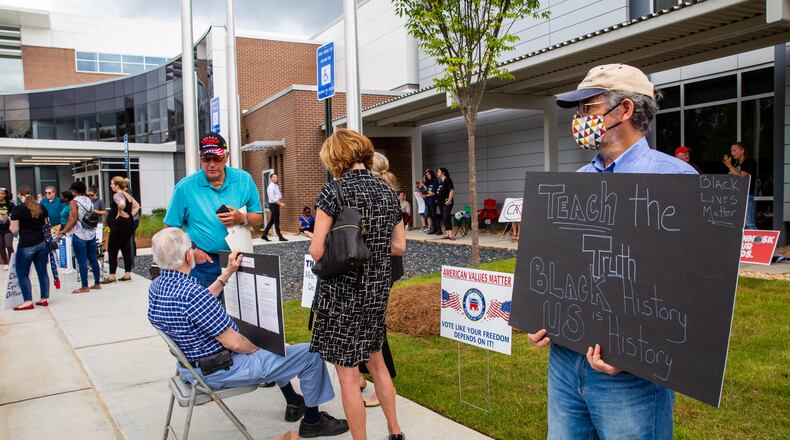 Before a Cobb County School Board meeting begins, Gregory Farino expresses his perspective as teachers, parents and local residents gather to voice their opinions on critical race theory and what Cobb County teaches and the reviews initiated by the school board Thursday, June 10, 2021.  (Jenni Girtman for The Atlanta Journal Constitution)