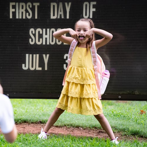 Corbitt VanDuzer, 6, strikes a pose for her mother, teacher Kathryn VanDuzer, before her first day of first grade at Glennwood Elementary School in Decatur, Ga., on Tuesday, July 30, 2024. (Seeger Gray/AJC)