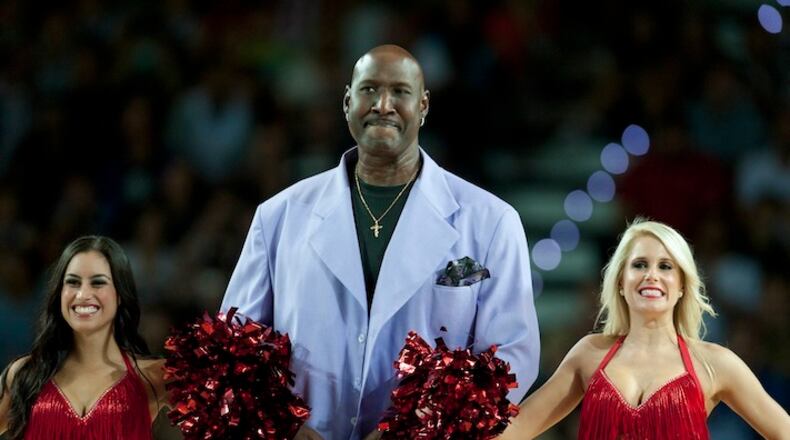 FILE - In this Oct. 6, 2013, file photo, former Philadelphia's 76ers' Darryl Dawkins, center, receives a tribute before a match against Bilbao Basket, during an NBA Global basketball game in Bilbao, northern Spain. Darryl Dawkins, whose backboard-shattering dunks earned him the moniker "Chocolate Thunder" and helped pave the way for breakaway rims, has died. He was 58. The Lehigh County, Pennsylvania coroner's office said Dawkins died Thursday morning, Aug. 27, 2015, at a hospital. (AP Photo/Alvaro Barrientos, File)