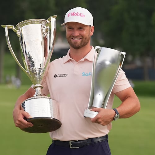 Wyndham Clark holds the Wanamaker Trophy and the BMW trohy after winning the BMW Championship golf tournament, Sunday, Aug. 23, 2026, in St. Louis. (AP Photo/Jeff Roberson)