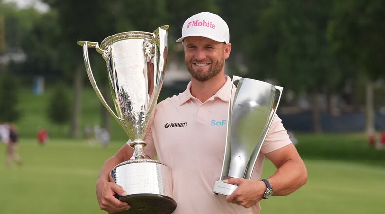 Wyndham Clark holds the Wanamaker Trophy and the BMW trohy after winning the BMW Championship golf tournament, Sunday, Aug. 23, 2026, in St. Louis. (AP Photo/Jeff Roberson)