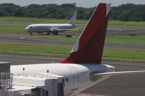 An aircraft with a Venezuelan flag taxis on the runway to another area of the Oscar Arnulfo Romero International Airport in San Luis Talpa, El Salvador, Friday, July 18, 2025. (AP Photo/Salvador Melendez)