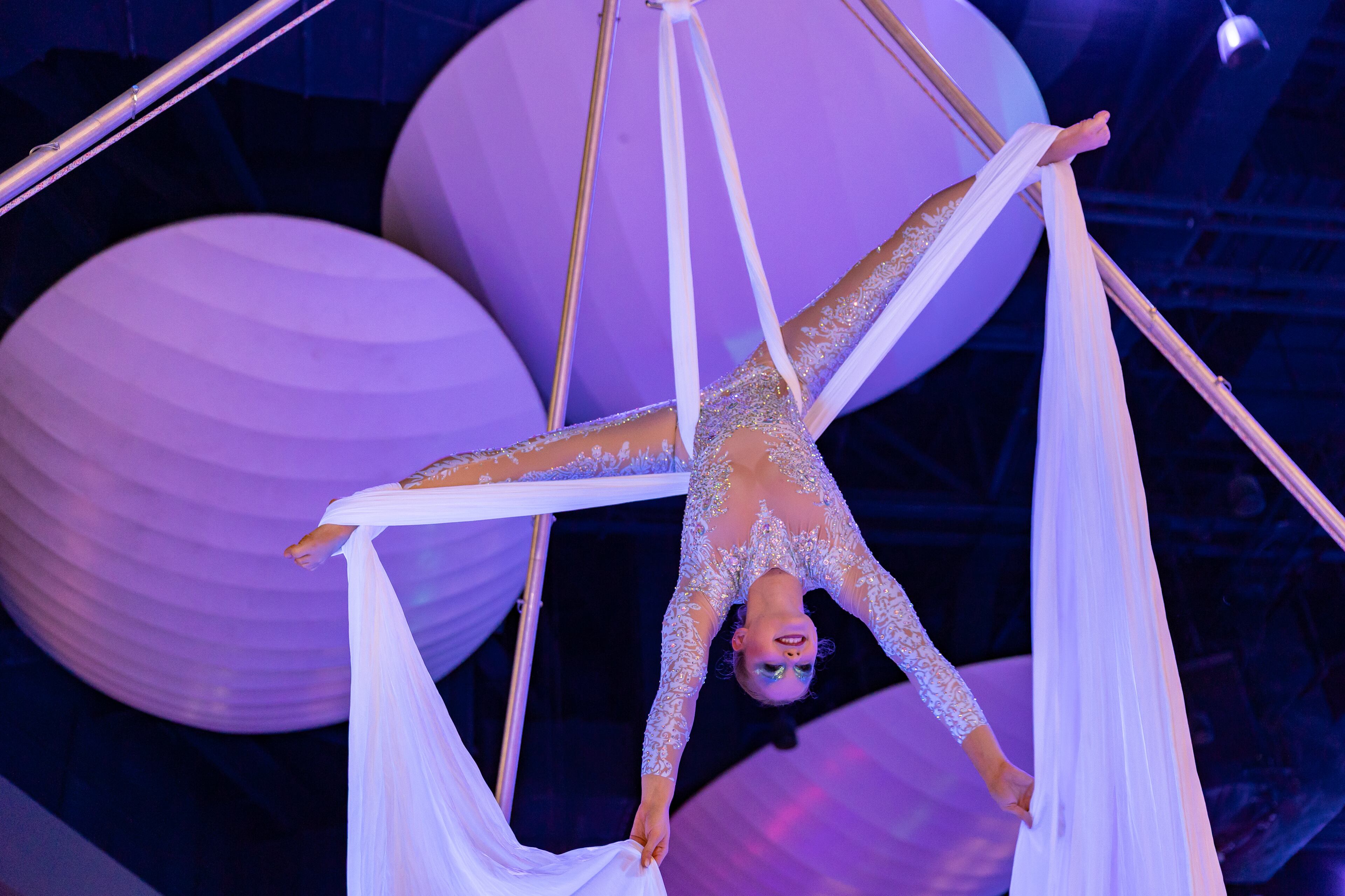 An aerial dancer performs during a dress rehearsal of Georgia Aquarium's Glow Nights, a new summer event that features jugglers, aerialists, sway pole artists and unicyclists. (Courtesy of Addison-Hill)
