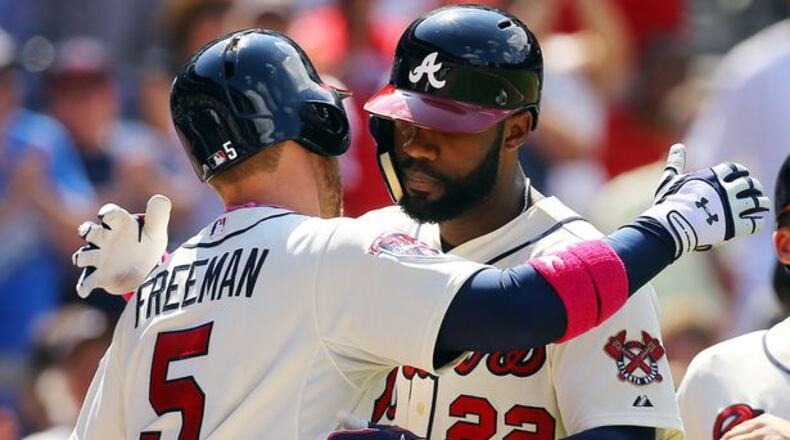 Jason Heyward gets a hug from Freddie Freeman after Heyward's two-run homer in Sunday's win against the Cubs, which ended a homerless drought of more than 100 at-bats for Heyward.