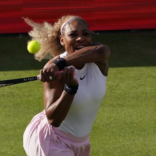 Serena Williams of the United States, hits a return as she and playing partner Victoria Mboko of Canada play against Nicole Melichar-Martinez of Canada and Erin Routliffe of New Zealand during their first round doubles match at the Queen's Club tennis championships in London, Tuesday, June 9, 2026. (AP Photo/Alberto Pezzali)
