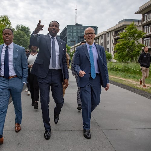 Atlanta Mayor Andre Dickens (center) strolls along the eastside Beltline trail in April, 2024. The mayor recently announced a proposal to expand all eight of the city's tax allocation districts, including the Beltline TAD, to fund more than $5 billion worth of projects. (Riley Bunch/AJC)