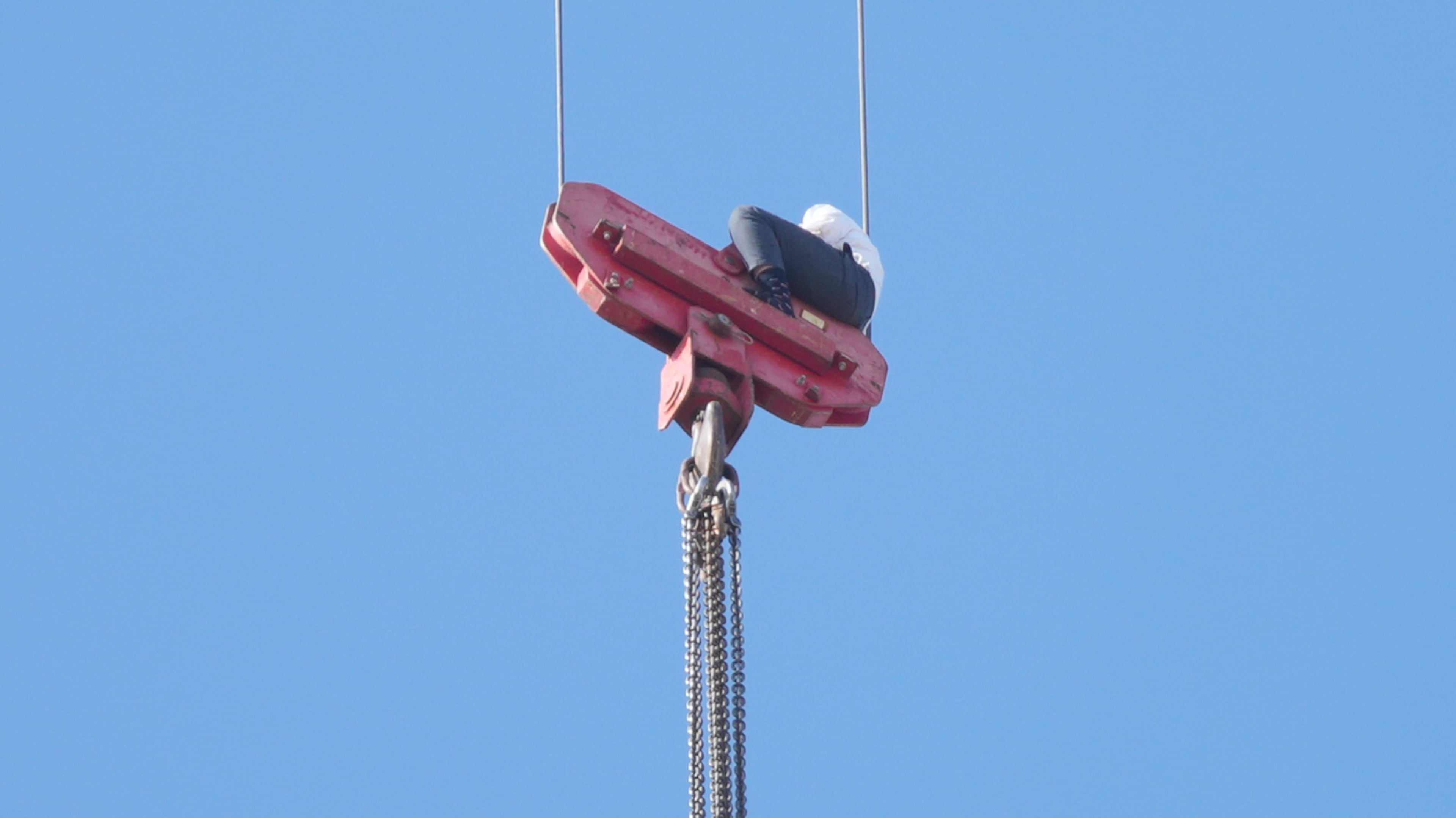 A teenager is seen trapped on a crane platform atop a skyscraper, where he dangled 36 stories up in the air for seven hours before being rescued, in Jerusalem Monday, Nov. 24, 2025. (AP Photo/Ohad Zwigenberg)