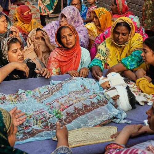 EDS NOTE: GRAPHIC CONTENT - Women mourn around the bodies of their children, who were killed in the roof collapse at a tutoring center that was under construction on the outskirts of Lahore, Pakistan, Wednesday, July 1, 2026. (AP Photo/K.M. Chaudary)