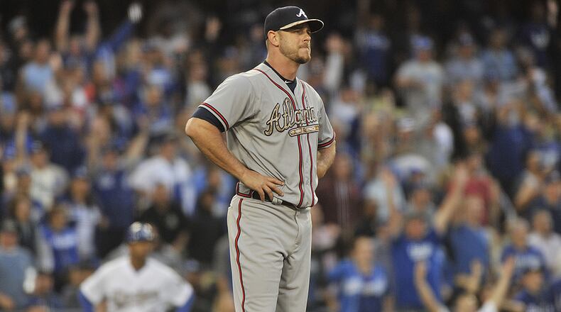 Braves pitcher Nick Masset reacts after giving up a two-run home run to Los Angeles Dodgers' Alex Guerrero in the eighth inning of a 6-3 loss in Los Angeles, Monday, May 25, 2015.