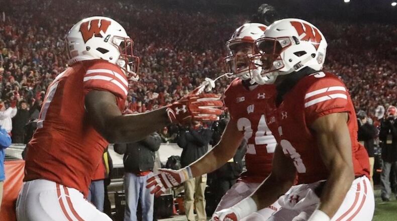 Wisconsin's Bradrick Shaw celebrates his touchdown run with Adam Krumholz (24) and Kendric Pryor (3) during the second half of an NCAA college football game against Iowa Saturday, Nov. 11, 2017, in Madison, Wis. (AP Photo/Morry Gash)