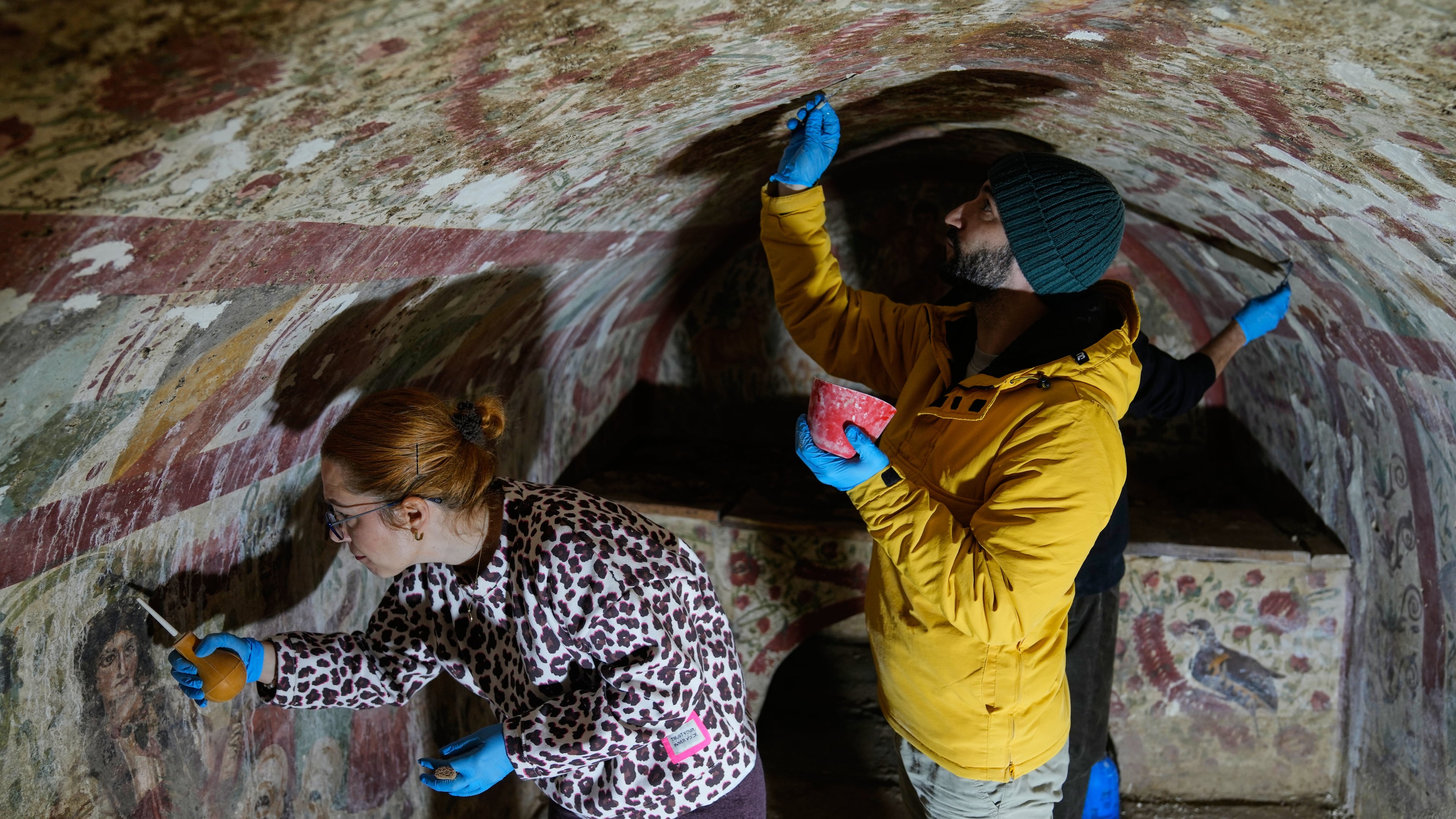 Archaeologists clean and restore frescoes inside a 3rd-century tomb where a rare early Christian depiction of Jesus as the "Good Shepherd" was discovered, in Iznik, Turkey, Friday, Dec. 12, 2025. (AP Photo/Khalil Hamra)