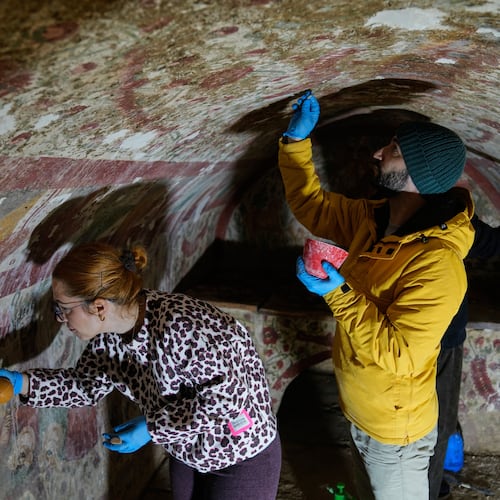 Archaeologists clean and restore frescoes inside a 3rd-century tomb where a rare early Christian depiction of Jesus as the "Good Shepherd" was discovered, in Iznik, Turkey, Friday, Dec. 12, 2025. (AP Photo/Khalil Hamra)