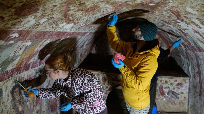 Archaeologists clean and restore frescoes inside a 3rd-century tomb where a rare early Christian depiction of Jesus as the "Good Shepherd" was discovered, in Iznik, Turkey, Friday, Dec. 12, 2025. (AP Photo/Khalil Hamra)