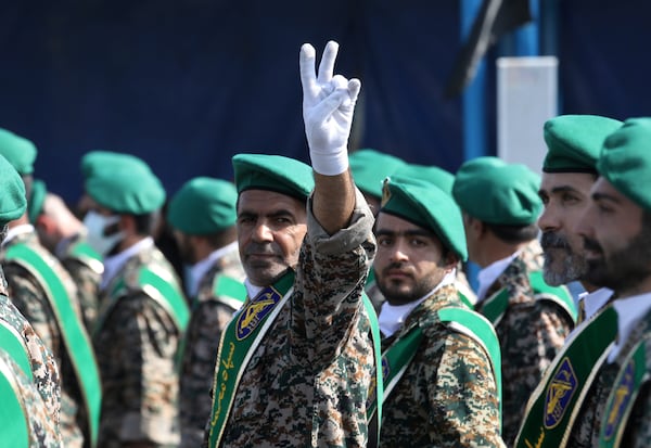 FILE - A member of Iran's Basij paramilitary force flashes a victory sign during a military parade outside of Tehran, Iran, on Sept. 22, 2022. (AP Photo/Vahid Salemi, File)