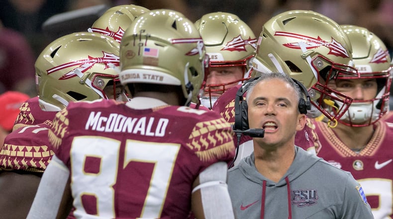 Florida State head coach Mike Norvell talks to his players during the first half of an NCAA football game against LSU on Saturday, Sept. 4, 2022, in New Orleans. (AP Photo/Matthew Hinton)