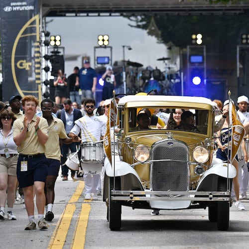Georgia Tech's Ramblin' Wreck leads the band, cheerleaders, Buzz, players and coaches before the start of the Yellow Jackets' home opener against Gardner-Webb on Oct. 6, 2025. (Hyosub Shin/AJC)