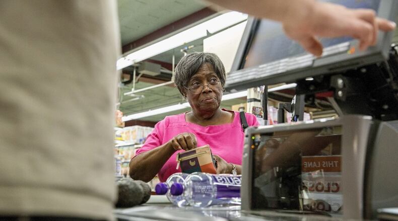 Marian Lewis, of Verona, buys avocados and bottles of water on Wednesday, Aug. 2, 2017 at the East End Food co-op. (Antonella Crescimbeni/Pittsburgh Post-Gazette/TNS)