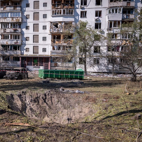 A missile crater is seen in the foreground, of a damaged apartment building following Russia's air attack in Kyiv, Ukraine, Thursday, Sept. 17, 2026. (AP Photo/Dan Bashakov)