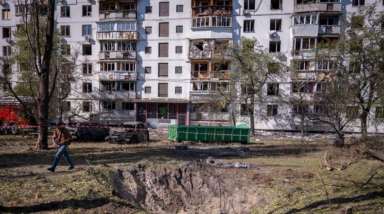 A missile crater is seen in the foreground, of a damaged apartment building following Russia's air attack in Kyiv, Ukraine, Thursday, Sept. 17, 2026. (AP Photo/Dan Bashakov)